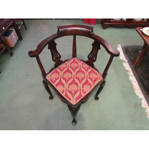 4215 - A Circa 1900 Arts & Crafts mahogany corner chair the scroll arms over pierced splat supports on pad ... 