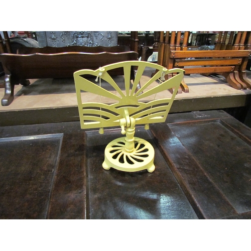 4227 - A cast iron pale yellow cookbook stand with sunburst design