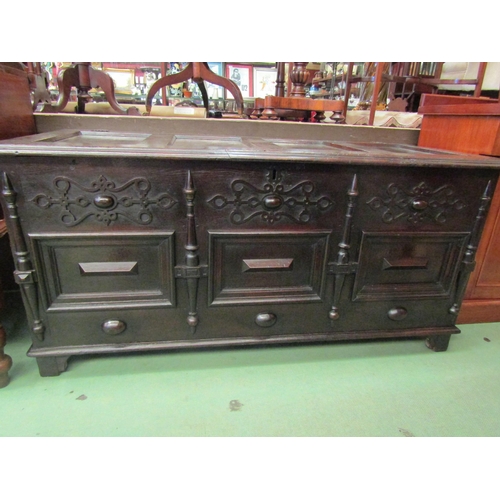4233 - A 17th Century pegged oak four panelled lid coffer with moulded front decoration over stile feet, 69... 