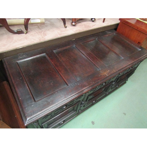 4233 - A 17th Century pegged oak four panelled lid coffer with moulded front decoration over stile feet, 69... 