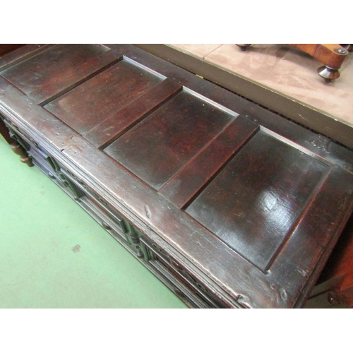 4233 - A 17th Century pegged oak four panelled lid coffer with moulded front decoration over stile feet, 69... 
