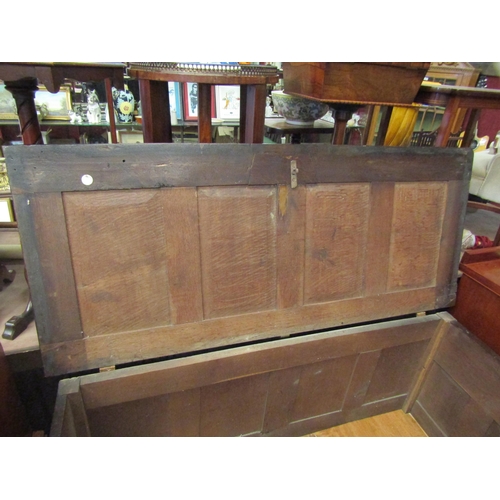 4233 - A 17th Century pegged oak four panelled lid coffer with moulded front decoration over stile feet, 69... 