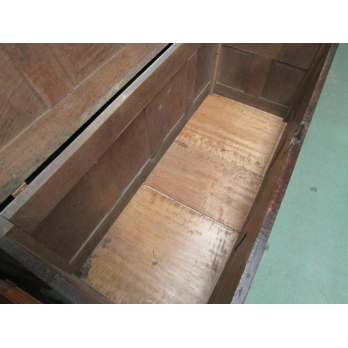 4233 - A 17th Century pegged oak four panelled lid coffer with moulded front decoration over stile feet, 69... 