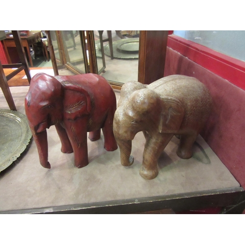 4018 - Two large carved wooden elephant figures, one red, tallest 31cm