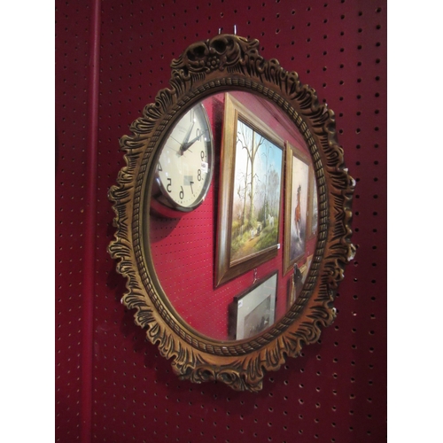 4068 - A gilt framed plaster oval wall mirror, 42cm x 32cm