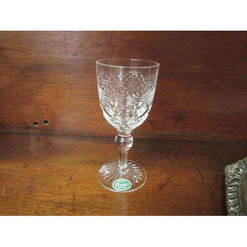 4079 - A silver plated tray, 27cm diameter, with six Stuart crystal sherry glasses