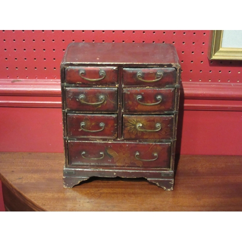 4103 - An Oriental lacquered table-top trinket chest of seven drawers, on bracket feet, 25cm tall