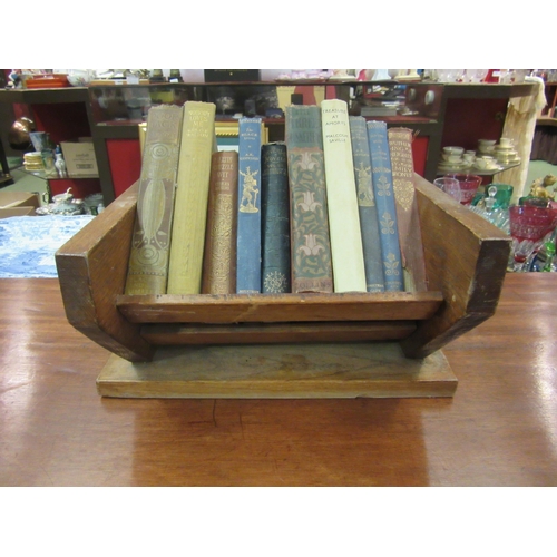 4133 - An oak book trough and ten vintage hardback novels including Emily Bronte, Aldous Huxley, Charles Di... 