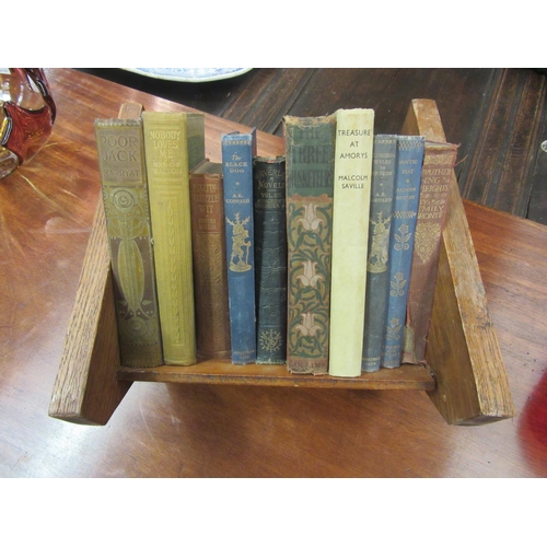 4133 - An oak book trough and ten vintage hardback novels including Emily Bronte, Aldous Huxley, Charles Di... 