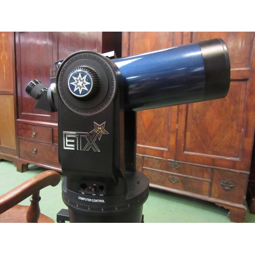 4199 - A Meade ETX telescope on tripod, with bag and case containing accessories including Autostar remote ... 