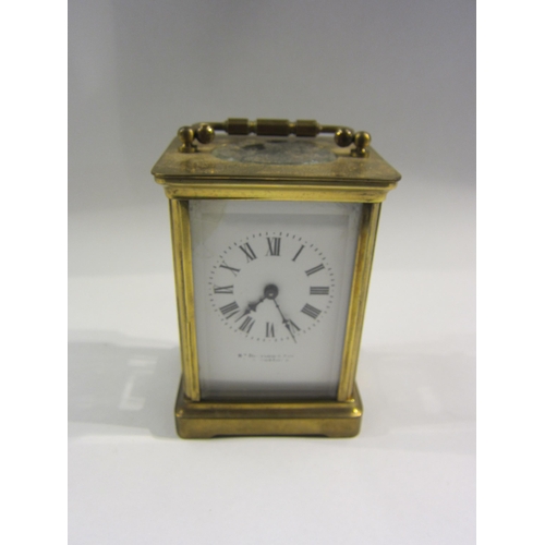 4370 - A Bedford & Son brass carriage clock with enamel Roman numeral dial, 11cm tall