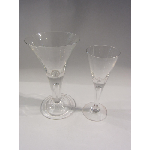 4379 - An ale glass with tear drop stem and folded foot, 18cm tall, and a similar smaller example (2)