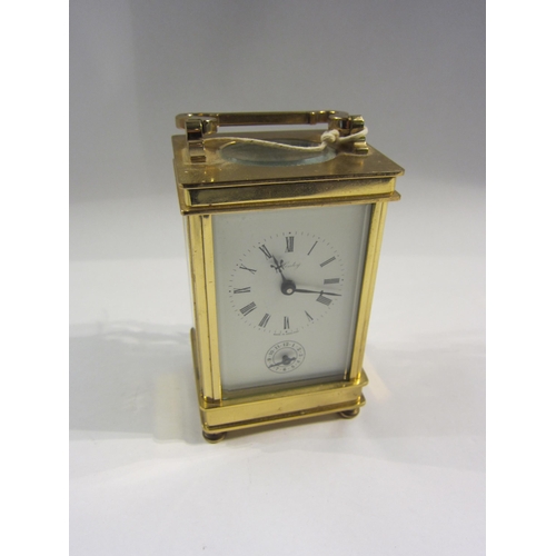 4380 - A Henley brass carriage clock, enamel Roman numeral dial, with key, 12cm tall