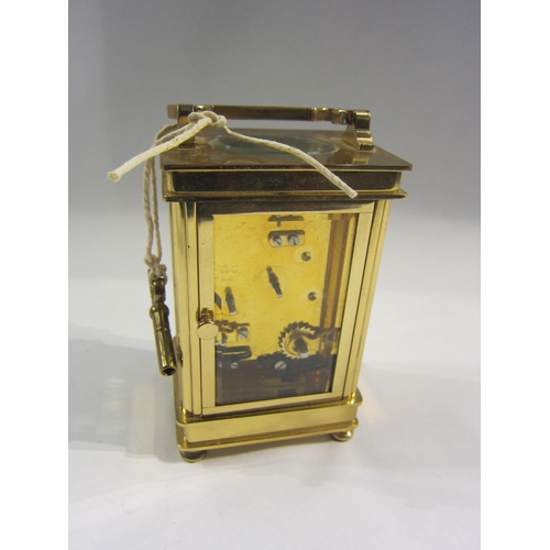 4380 - A Henley brass carriage clock, enamel Roman numeral dial, with key, 12cm tall