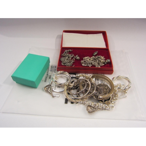 4399 - A quantity of white metal and silver jewellery including charm bracelets and bangle etc