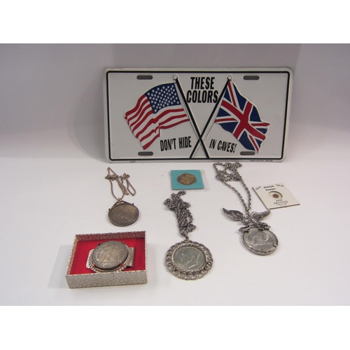 4412 - A small selection of US dollars in mounts including Morgan silver dollar, also a tin sign