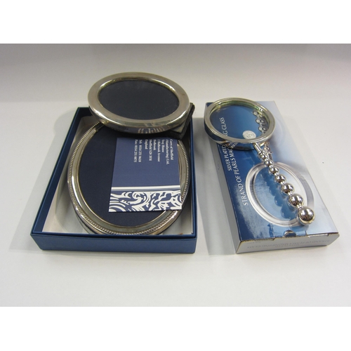 4415 - Two silver oval photograph frames and a magnifying glass