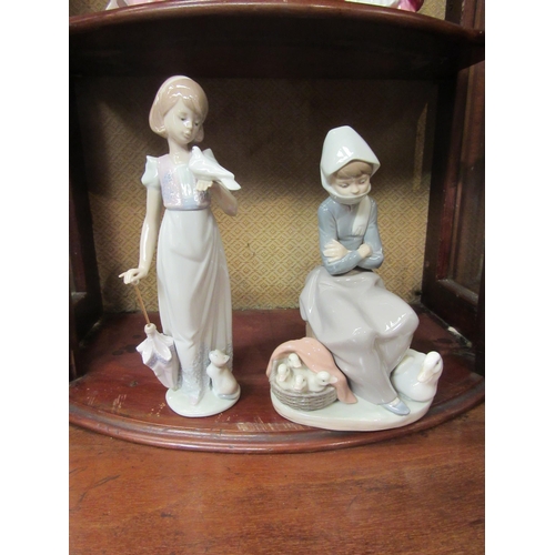 4096 - Two Lladro figural groups, girl seated with goose at her feet and basket of chicks and a girl with d... 