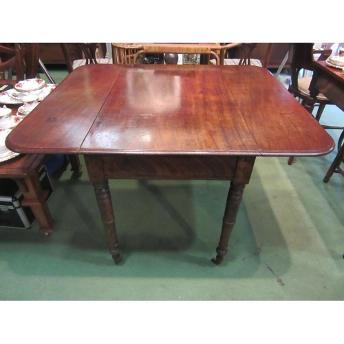 4205 - A 19th Century mahogany Pembroke table on turned legs to brass castors, 70cm tall x 111cm long x 96c... 