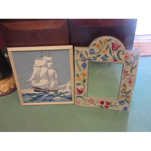 4214 - A wall mirror with floral embroidered frame, 57cm x 41cm, together with tapestry of a ship, framed, ... 