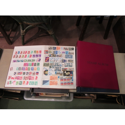 4225 - A stamp album part filled with British stamps, an album of World stamps, a similar album, and a Sena... 