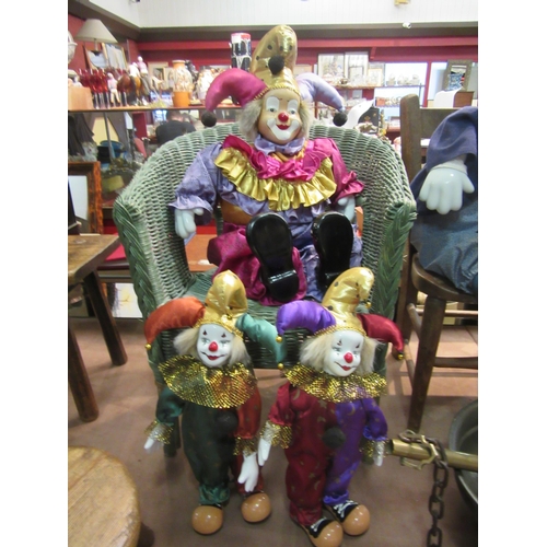 4251 - Four clowns, three with porcelain heads, the two smaller being clockwork musical, tallest 43cm