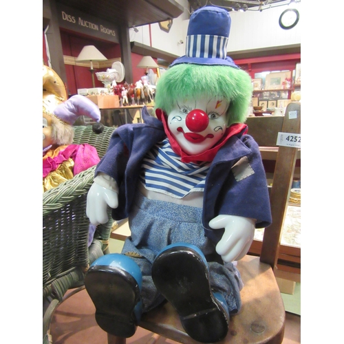 4251 - Four clowns, three with porcelain heads, the two smaller being clockwork musical, tallest 43cm