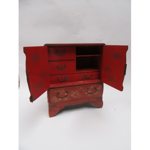 6020 - A Japanese lacquered jewellery cabinet, two doors with coastal scene, over a single long drawer, enr... 