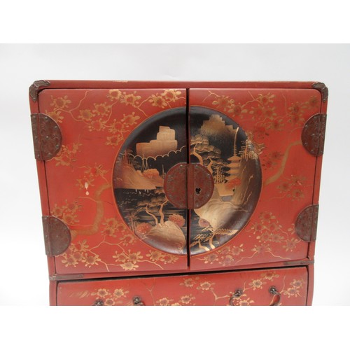 6020 - A Japanese lacquered jewellery cabinet, two doors with coastal scene, over a single long drawer, enr... 