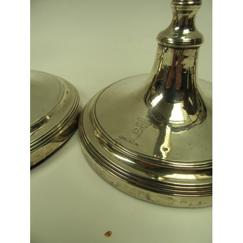 6383 - A set of four John Parsons & Co Georgian silver candlesticks with weighted bases, faint crested deta... 