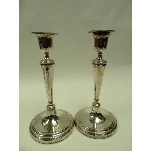 6383 - A set of four John Parsons & Co Georgian silver candlesticks with weighted bases, faint crested deta... 