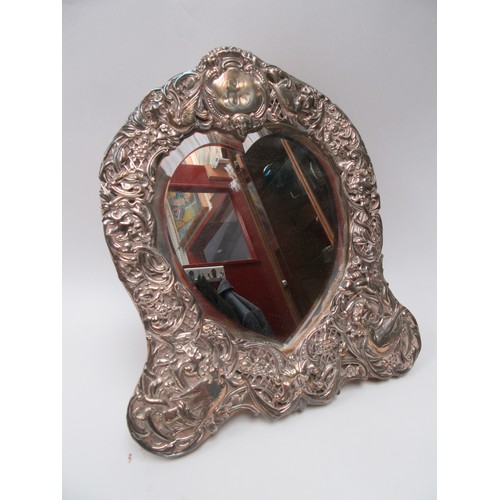 6374 - A William Comyns silver highly ornate mirror frame decorated with birds, flowers and leaves, heart s... 