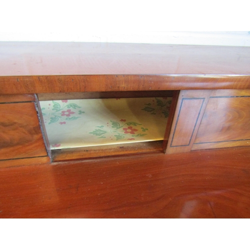 1016 - A Regency mahogany sideboard, shaped front with two central drawers and a pair of convex drawers on ... 