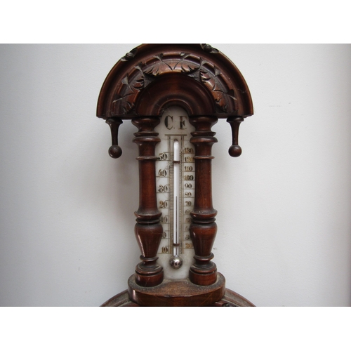 1047 - A 20th Century wall barometer with finial design, 46cm tall