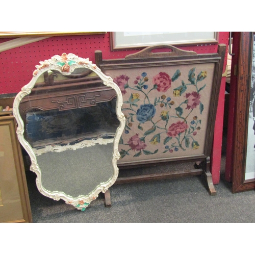 1065 - An oak framed floral tapestry firescreen and a shabby chic painted mirror with floral decoration