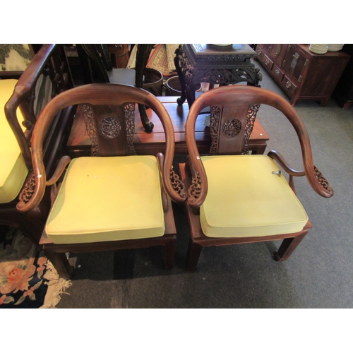 1076 - An Oriental rosewood lounge set consisting of four armchairs and one settee, pierced fretwork back s... 