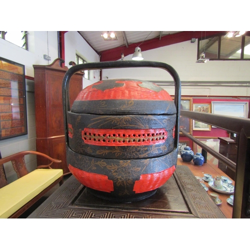 1081 - An Oriental sectional rice container, ebonised and red lacquered with gilt floral decoration, 25cm t... 