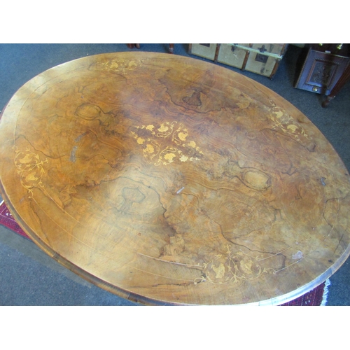 1024 - A Victorian walnut oval top loo table, marquetry inlay, 72cm tall x 130cm long x 95cm wide