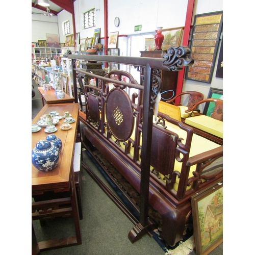 1088 - An Oriental hardwood hanging frame with scrolled foliage design, 160cm tall x 250cm long approximate... 