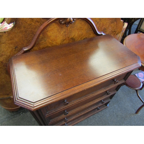 1101 - An oak canted corner four drawer chest, 77cm tall x 85cm wide x 41cm deep