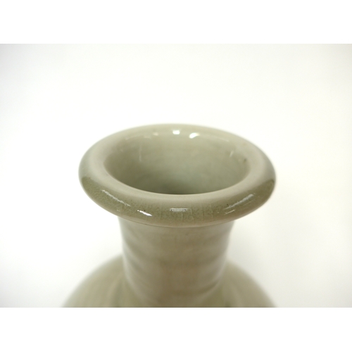 7143 - WILLIAM 'BILL' MARSHALL (1923-2007) A studio pottery porcelain bottle vase, pale celedon glaze, impr... 