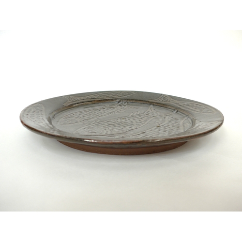 7155 - An Abuja studio pottery plate with incised fish detail. Seal to side mostly filled with glaze. Chris... 