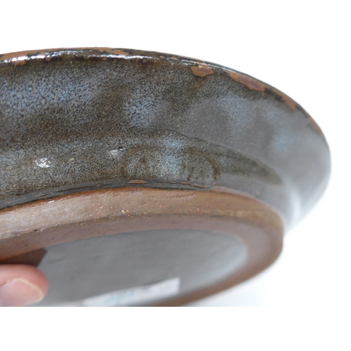 7155 - An Abuja studio pottery plate with incised fish detail. Seal to side mostly filled with glaze. Chris... 