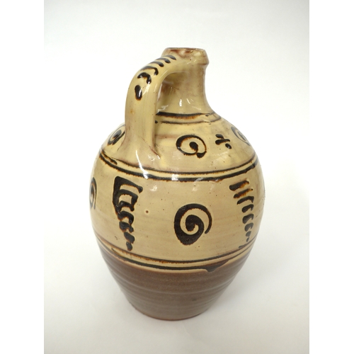 7158 - A Winchcombe Pottery flagon with painted tenmuko motifs over slip. Turned wooden tap. Impressed pott... 