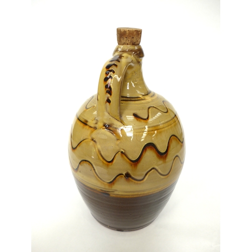 7157 - A Winchcombe Pottery flagon probably by Ray Finch with ochre glaze and painted wave line detail. Imp... 