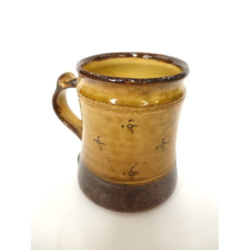 7054 - A Winchcombe Pottery Tankard with ochre glaze and incised motif decoration. Impressed pottery seals ... 