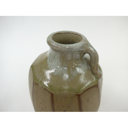 7053 - MIKE DODD (b.1943) A studio pottery facet cut sided vase with single loop handle. Impressed seal. 19... 