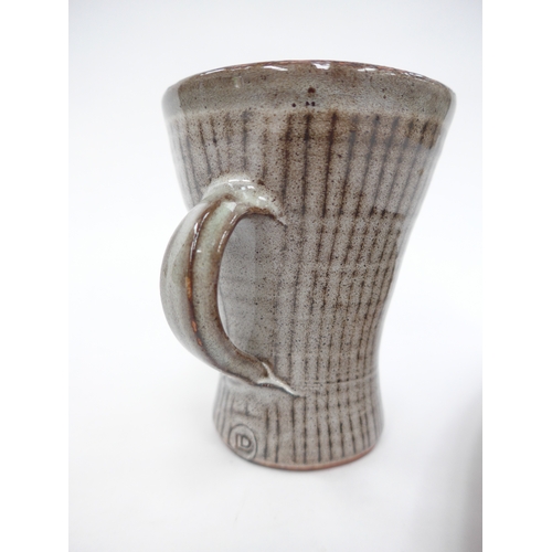 7148 - DAVID LEACH (1911-2005) A studio pottery mug with line detail, 10.5cm high (grazes to rim) and a lon... 