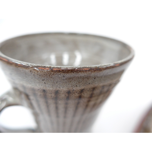 7148 - DAVID LEACH (1911-2005) A studio pottery mug with line detail, 10.5cm high (grazes to rim) and a lon... 