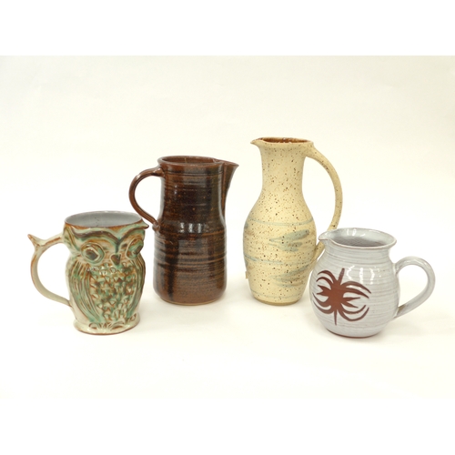 7069 - Four studio pottery jugs to include Clive Pearson, Mildred Slatter, Michael Skipwith and an owl tank... 